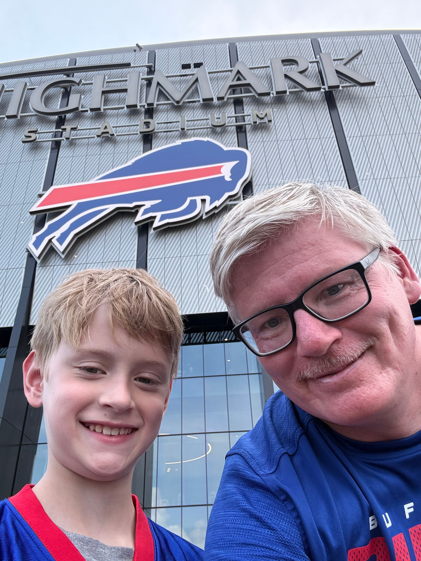 Artur and his son outside Highmark Stadium in Buffalo.